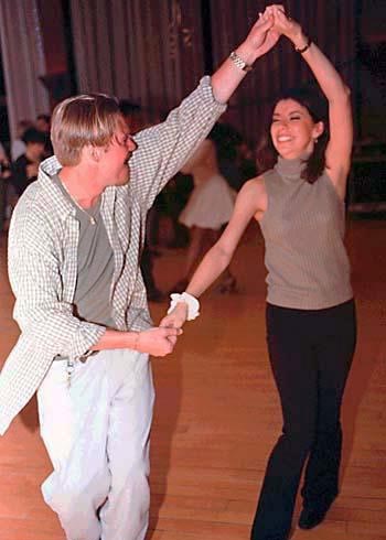man and woman salsa dancing