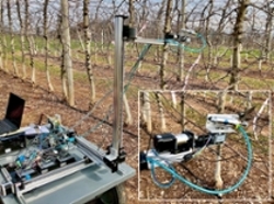 Image of robotic device pruning apple trees