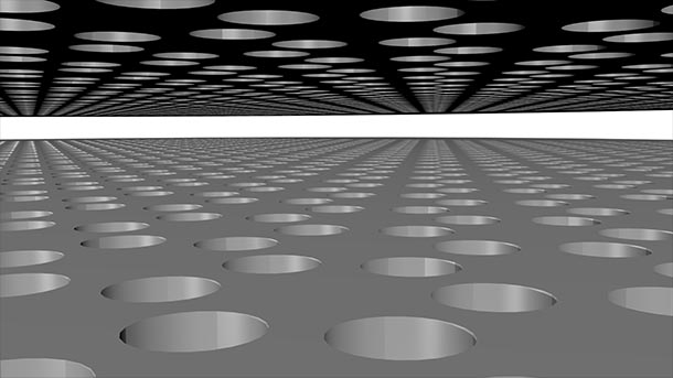 A computer-generated illustration shows two layers of solid material with holes in a hexagonal pattern in each layer.