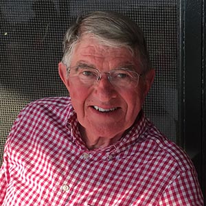 headshot of a man wearing a plaid shirt