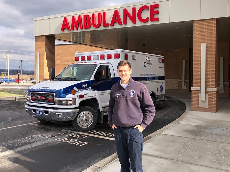 a man in front of an ambulance outside of a hospital