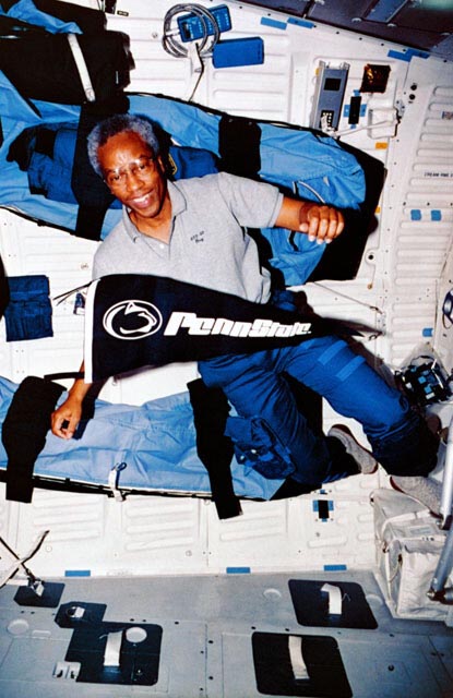 Guy Bluford in space with Penn State banner