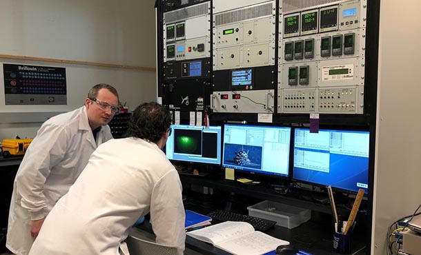 Two men reviewing information on computer screen in a laboratory
