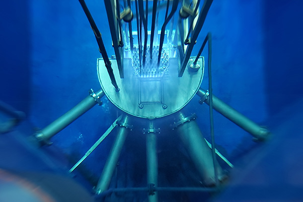 A metal contraption with five tubes sits in blue water