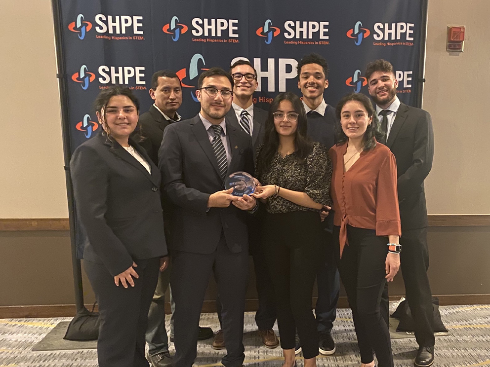 group of hispanic students pose for photo after receiving award