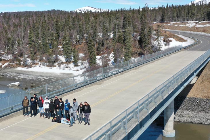 aerial drone image of students standing on bridge in Alaska 