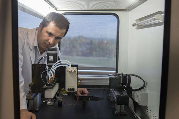 A person leans over scientific equipment