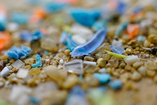 pieces of multi-colored plastics mixed in with small stones