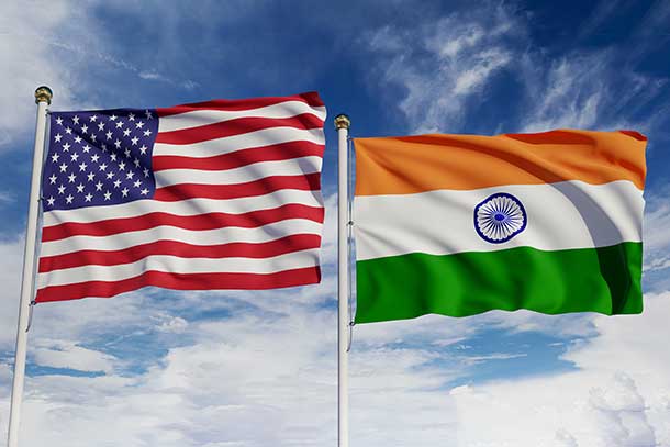 U.S. flag and Indian flag wave on flag poles next to each other