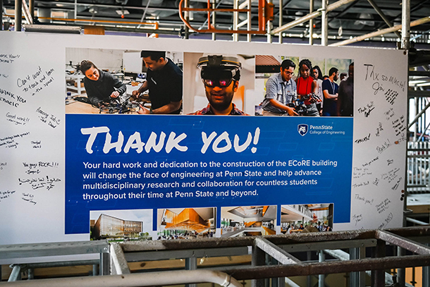  a sign thanking workers hanging in an area under construction in a new building