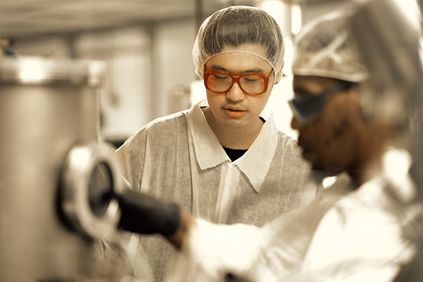 Two people work in a cleanroom.