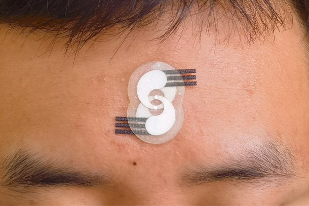 An electrochemical sensor is seen on a forehead.