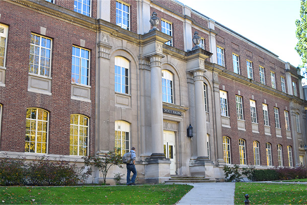 the exterior of a brick building with columns.