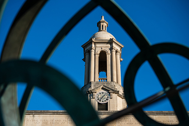 view of a bell tower through a fence