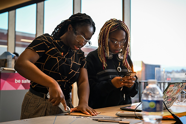  Two students collaborate on an engineering project.