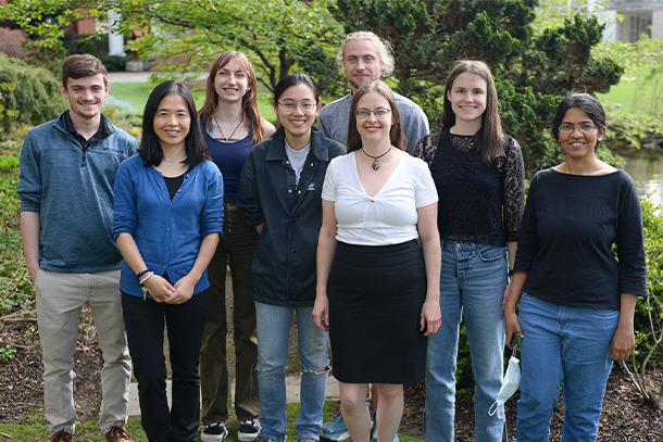 a group of researchers stand outside smiling for a photo
