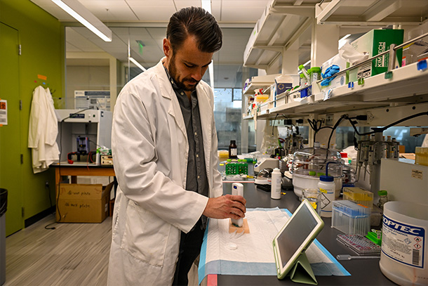 individual wearing white lab coat working in a lab