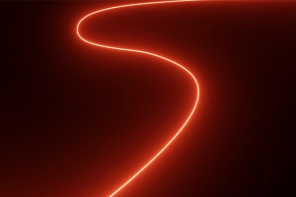 image of red light in an "s" shape with darkness all around it.