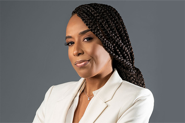 headshot of an individual in a white jacket.