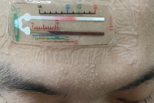 A sensor attached to a person's forehead