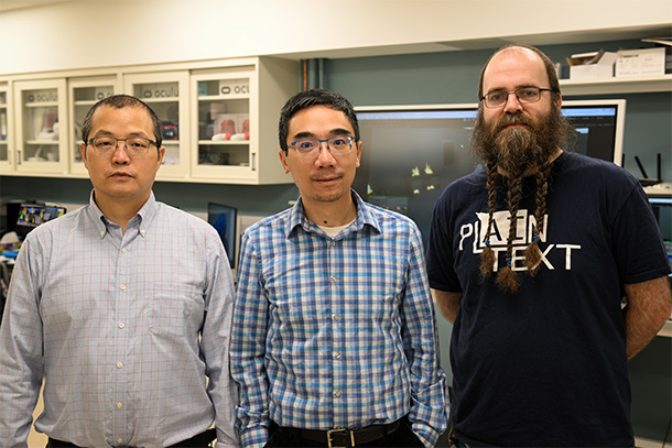 A posed photo of three people in a lab.