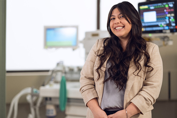 individual standing in front of medical equipment.