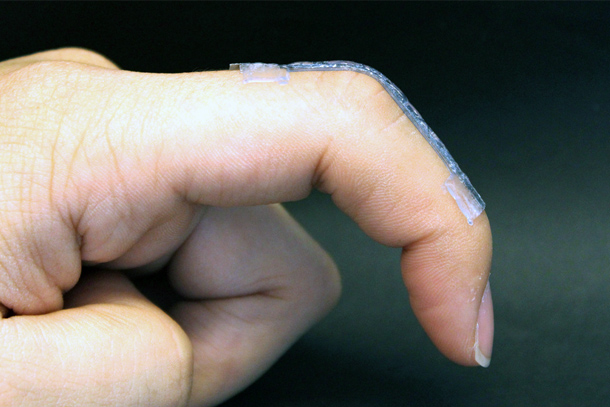 A sensor conforms to a finger as the finger bends. 