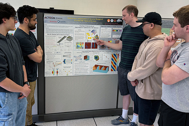 students viewing a poster presentation