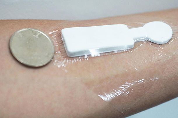 An outstretched arm with the emotion sensor stuck to it 