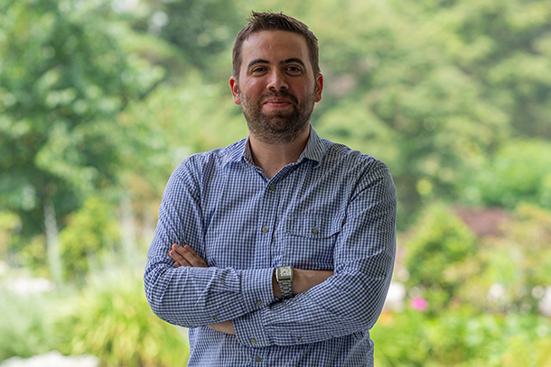 An outdoor portrait of a person in a blue shirt.