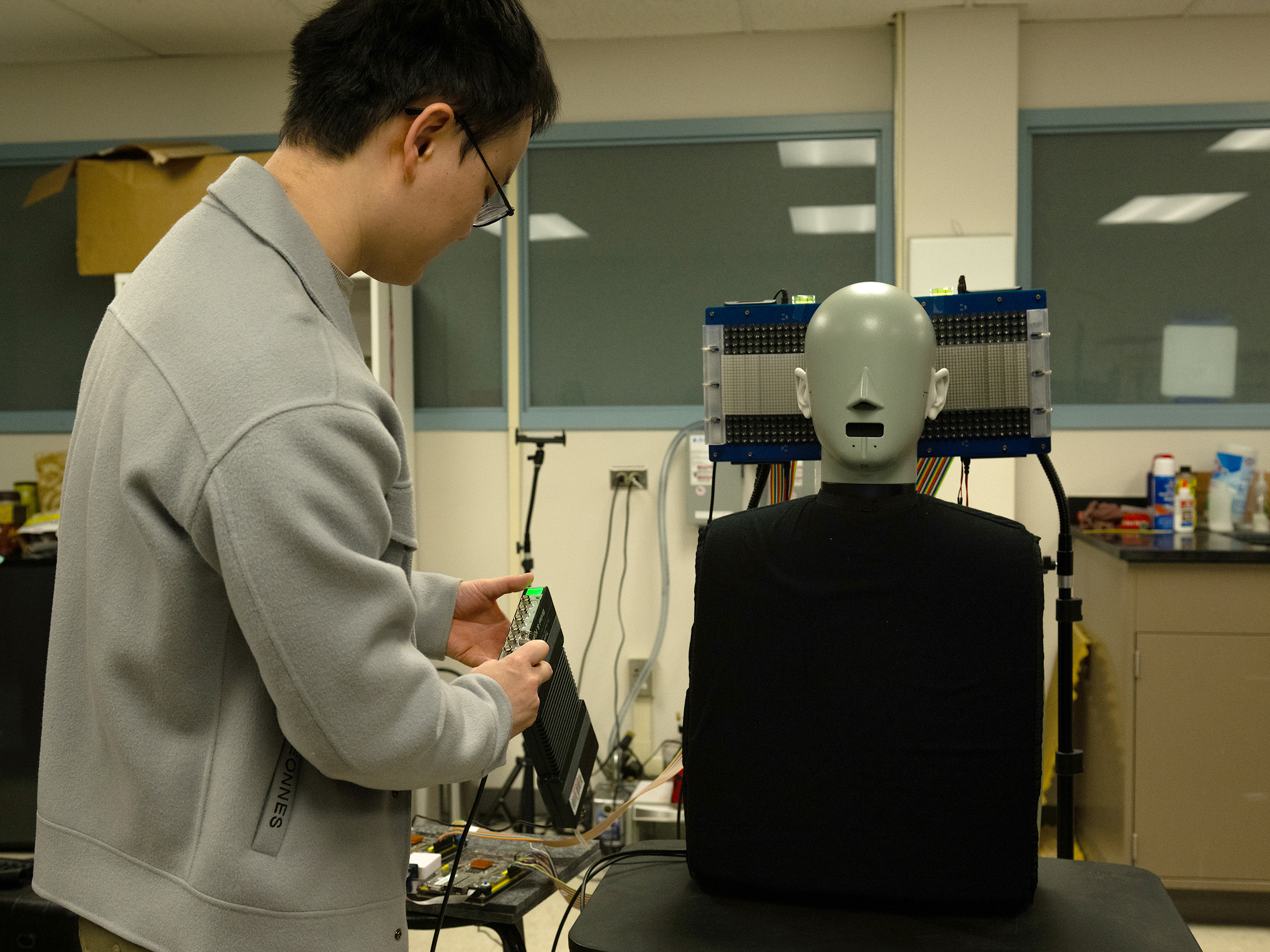  A researcher manipulates a dummy in a lab.  