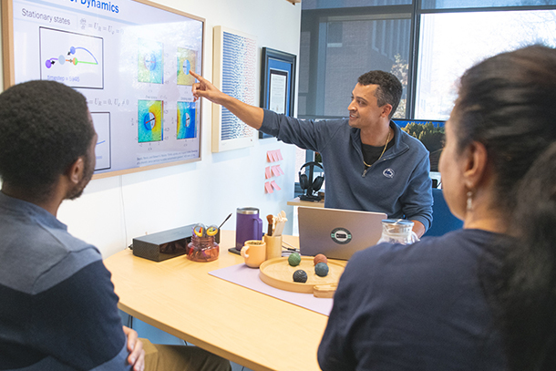 A team of researchers looking at a graphic on a screen