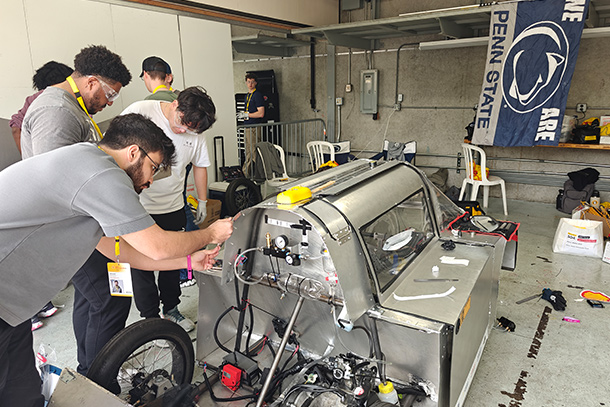 Students working on creating a car for a competition.