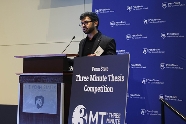 Man standing at podium discussing his research for competition