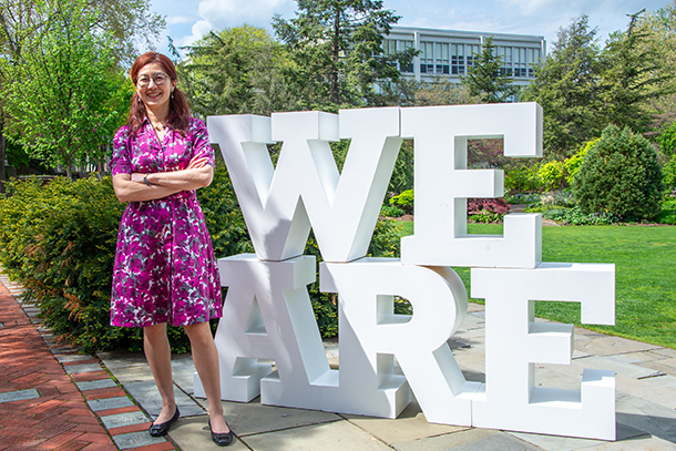 individual poses in front of We Are lettering