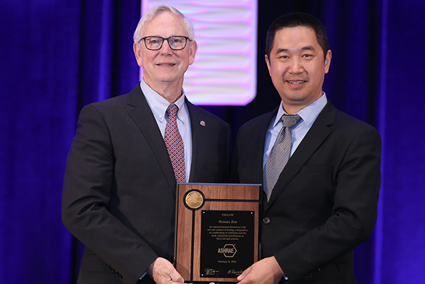  Person receiving award from international engineering institution. 