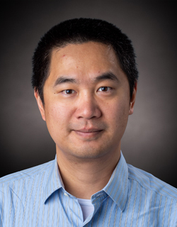 A professor of architectural engineering and architectural engineering poses for a headshot.  
