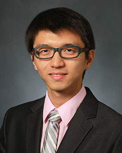 professor in suit and tie poses for professional headshot photo